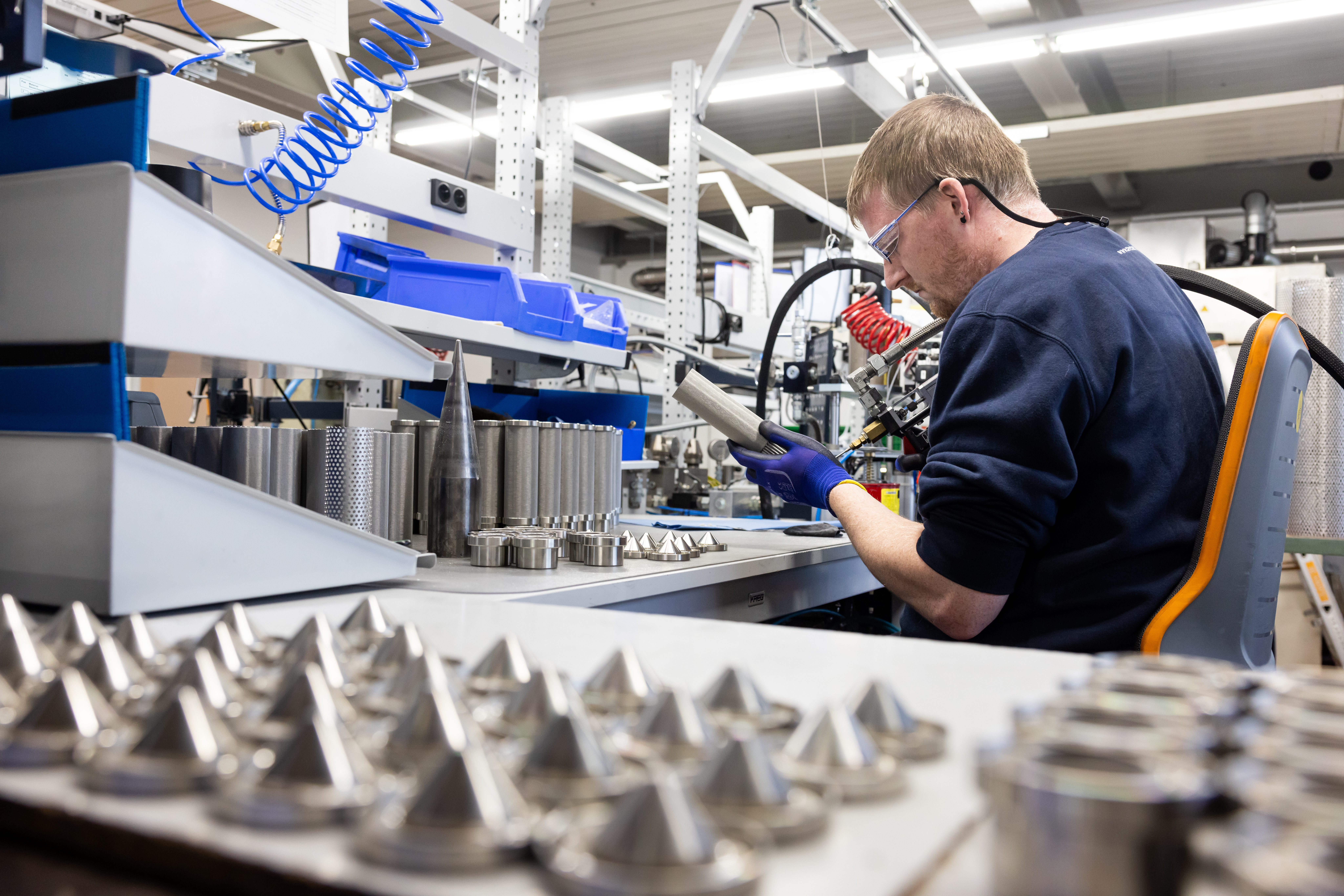 Employee Wearing Safety Goggles Inspecting Product