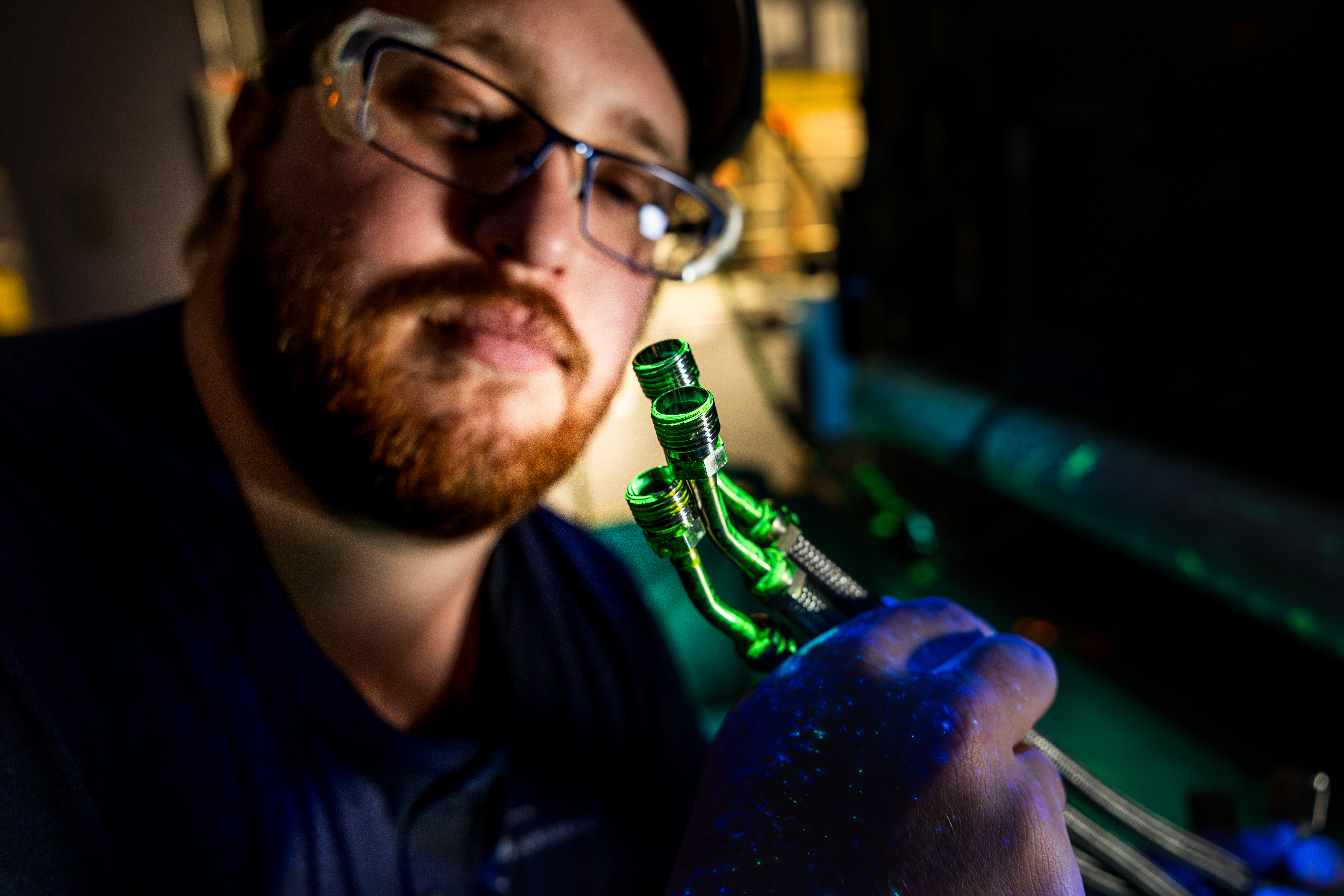 Employee Wearing Safety Glasses Inspecting Product