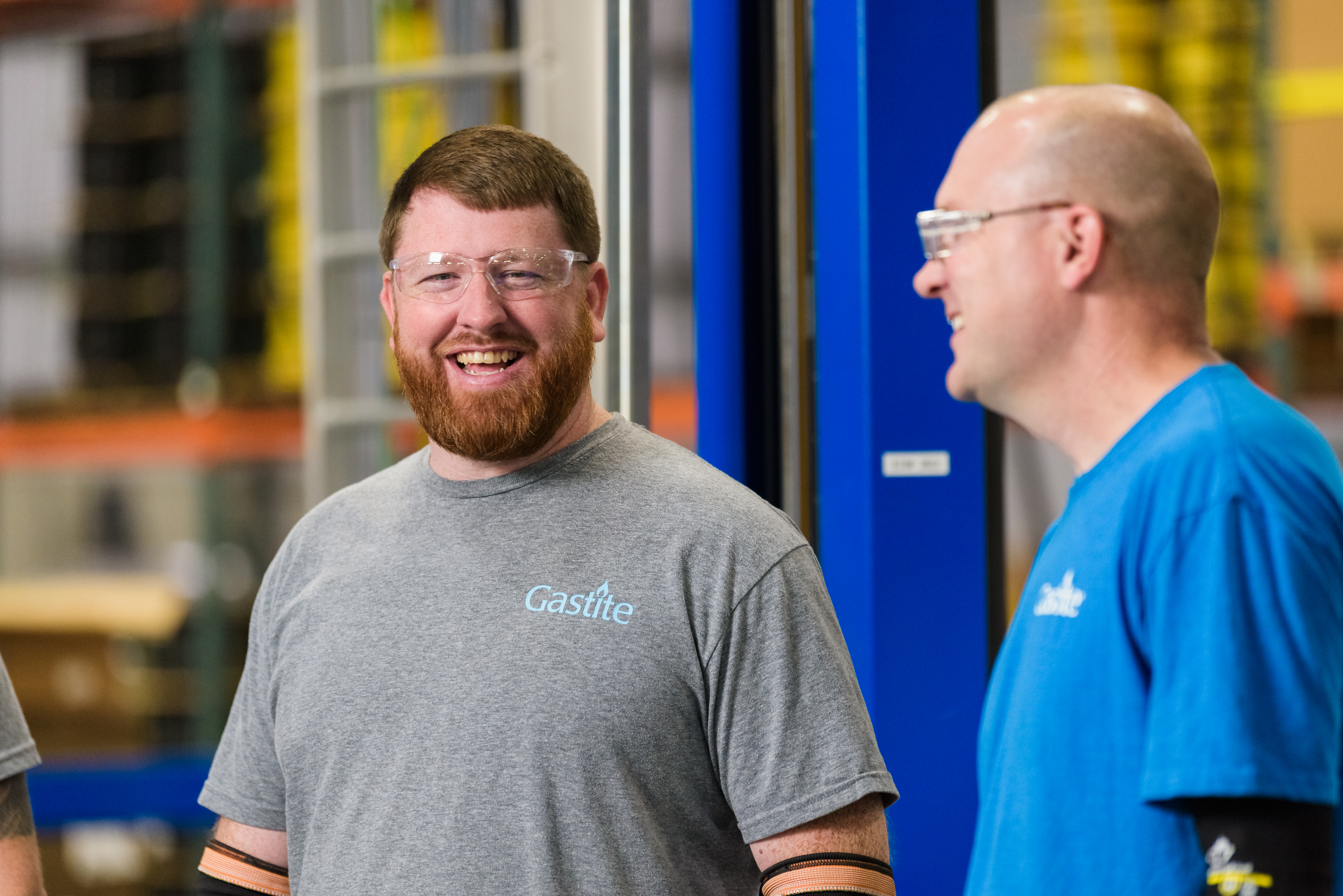 Two Colleagues In Goggles Laughing