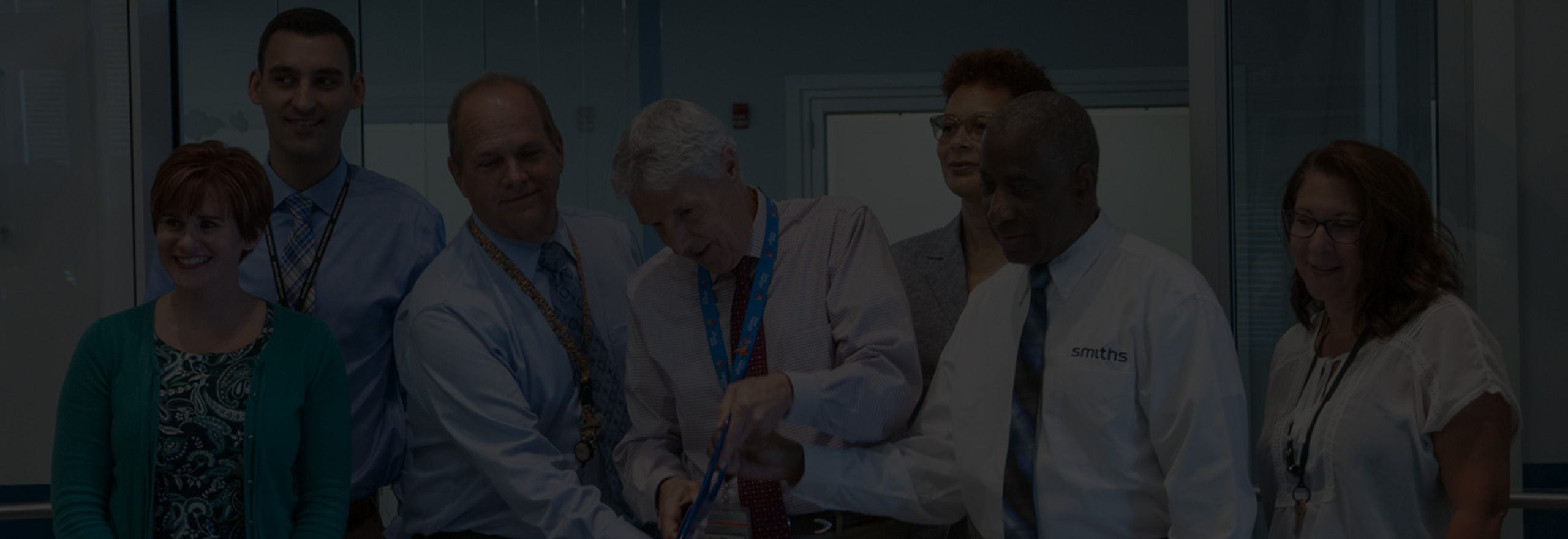 People at the cutting of a ribbon