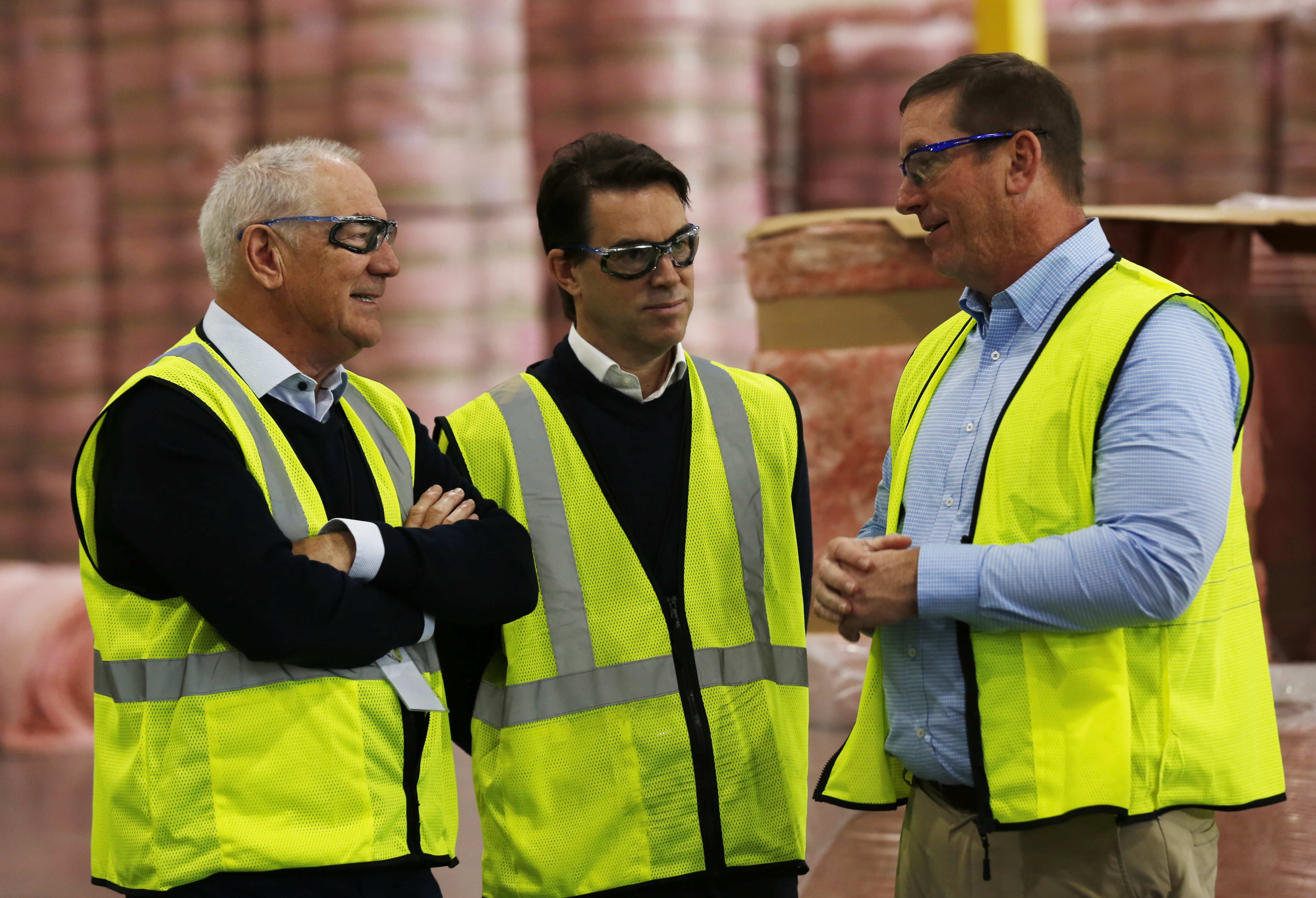 Directors On Site Visit Wearing Safety Glasses And Hi Vis Vests