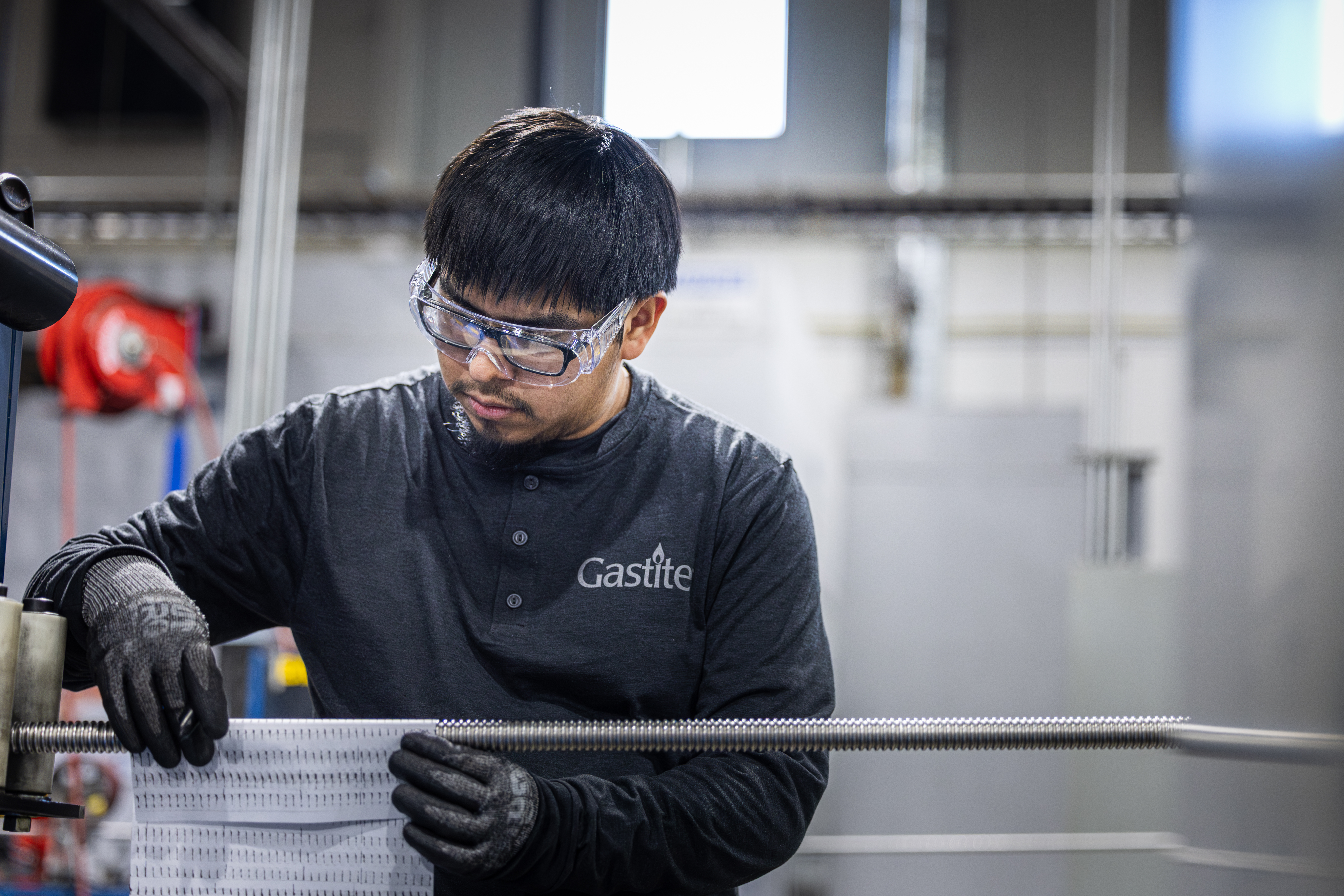 Man Wearing Gastite Top And Safety Glasses Working