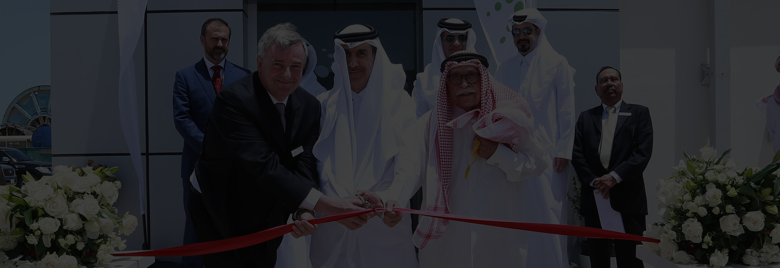 People cutting red ribbon